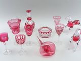 many different pink glass items on a white surface