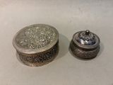 a silver box sitting next to a silver box on a table