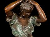 bronze statue of a woman holding her head in her hands