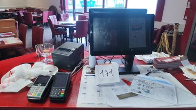 a computer monitor sitting on a desk with papers and a calculator