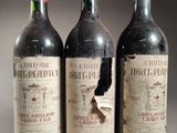 trois bouteilles de vin rouge posées côte à côte sur une table
