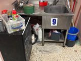 a kitchen with a sink and a refrigerator in it