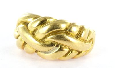 a close up of a gold ring on a white surface