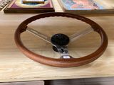 a wooden steering wheel on a table in a room