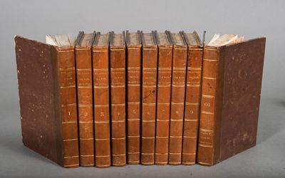 six old books stacked on top of each other on a table