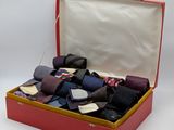 many ties in a red box on a white background