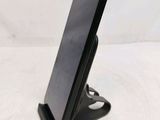 a cell phone that is on a stand on a table