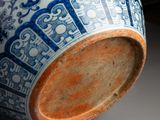 a blue and white vase sitting on a table