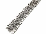 a close up of a silver bracelet on a white background