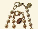 a close up of a chain with a coin on it