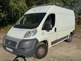 a white van parked in a lot with trees in the background