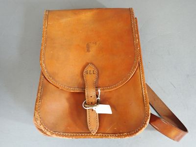 a brown leather bag with a white tag on it