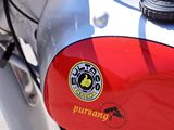 a close up of a red and silver motorcycle with a sticker on it