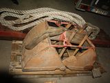 a pile of old shoes on a pallet with a rope