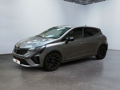 a grey car is parked in a room with a white wall
