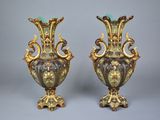 pair of antique vases with green and gold decoration on them