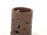 a wooden cup with carvings on it on a white surface
