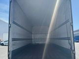 the back of a white truck parked in a parking lot