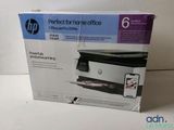the box is open on the table with the printer in it