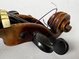 a close up of a violin on a white surface