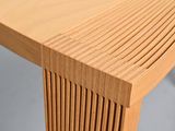 a close up of a wooden table with a curved top