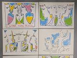 four different colored drawings of people on white paper on a gray surface