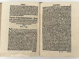 an open book on a white surface with a black border