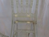 two white chairs sitting next to each other on top of a white sheet