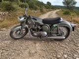 une moto garée sur le bord d'un chemin de terre
