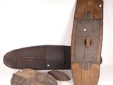 a surfboard and a pair of shoes on a white surface