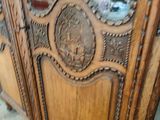 a large wooden cabinet with a mirror on top of it