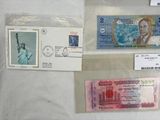 several different stamps and stamps on a table with a picture of the statue of liberty in the background