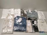 a lot of men ' s shirts in bags on the table