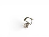 a close up of a silver earring on a white background