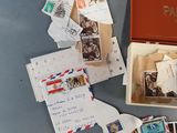 a box with a bunch of postcards in it on a table