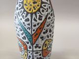 a white vase with a colorful design on it