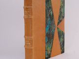 an orange book with a green and blue design on the cover