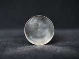 a close up of a glass ball sitting on top of a black surface