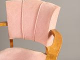 an image of a pink chair with a wooden frame and a pink upholstered seat