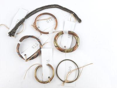 several bracelets with tags and tags on them on a white surface