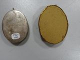 two oval lockes that are sitting next to each other