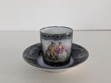 a close up of a cup and saucer on a table