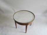 une image représentant une petite table ronde avec un plateau en marbre