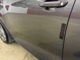 a close up of a car door handle with a sticker on it