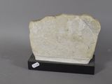 a close up of a stone block on a stand on a gray surface