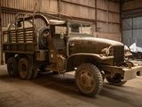 a old military truck parked in a garage