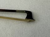 a bow that is laying on a white surface