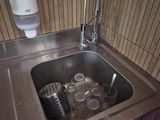 a sink that has a lot of cups in it