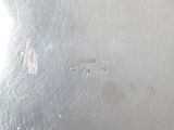 silver plate with the word gucci engraved on it