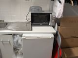 a small kitchen with a refrigerator and a microwave in it